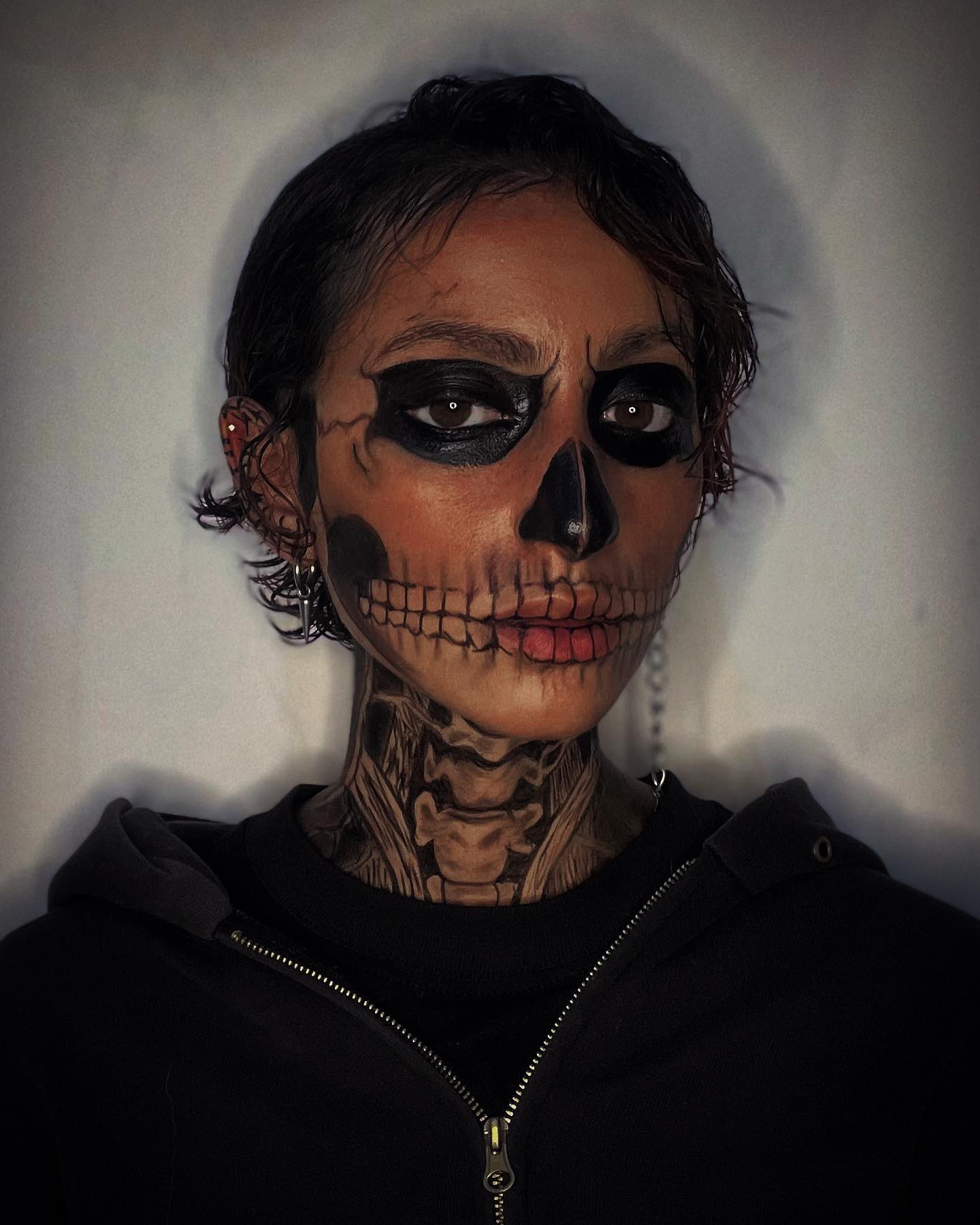 Skeletal face-paint study with black eye sockets and detailed teeth