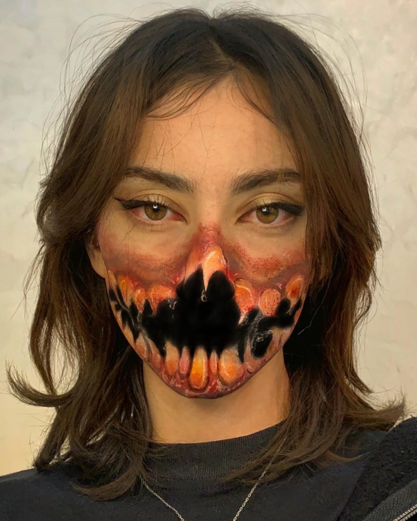 Special-effects study with a monstrous mouth painted across the lower face